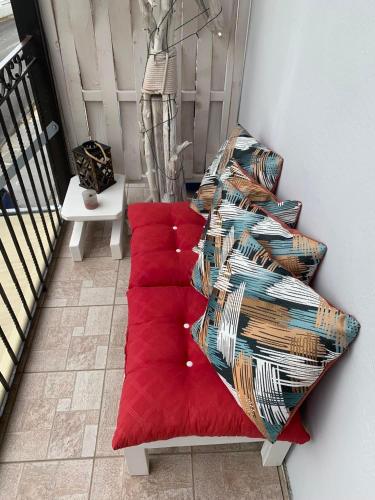 a group of red pillows sitting on a staircase at Mary's apartment in Stomio