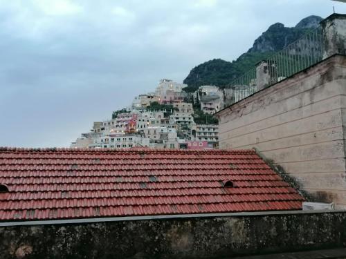 a view of a mountain with a red roof at POSITANO CENTRAL HOUSE free wi-fi and air condition in Positano