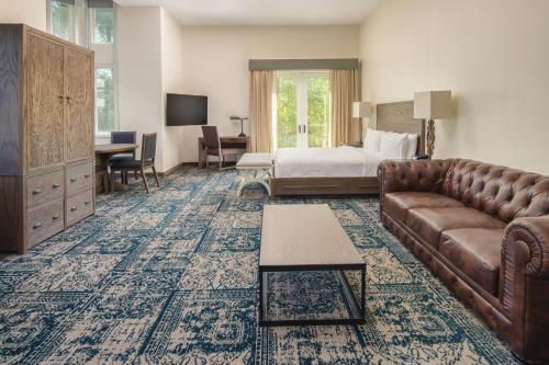 a hotel room with a couch and a bed at Four Points by Sheraton Santa Cruz Scotts Valley in Scotts Valley