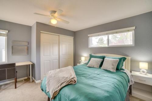 a bedroom with a green bed with a ceiling fan at Dog-Friendly Denver Vacation Home with Gas Grill! in Denver
