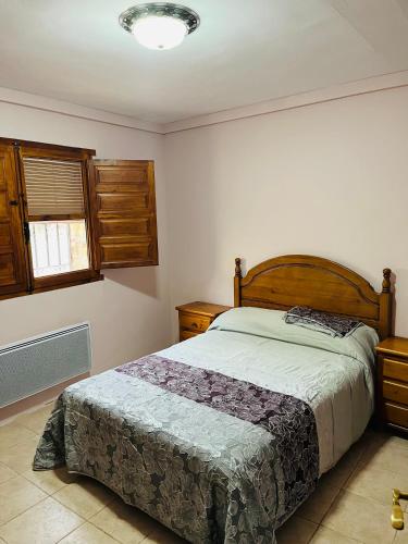 a bedroom with a bed and a window at Casa del Espliego in Barriopedro