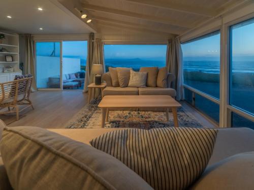 a living room with a view of the ocean at CASA MARIA - BEACHFRONT COTTAGE ON THE SAND in Ensenada