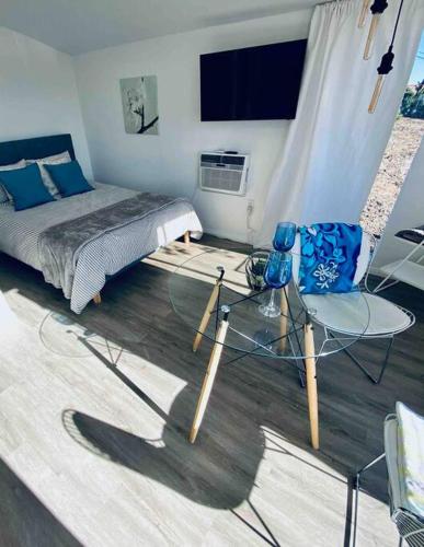 a bedroom with a bed and a glass table and chair at 30 PCT OFF! Malibu Serene Cabin, Ocean View, Beach in Malibu
