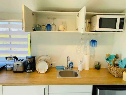 a kitchen counter with a sink and a microwave at 30 PCT OFF! Malibu Serene Cabin, Ocean View, Beach in Malibu