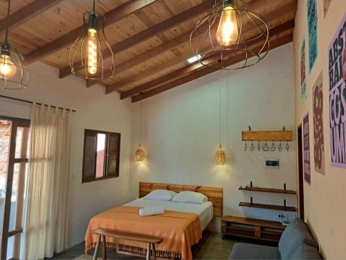 1 dormitorio con 2 camas, luces y sofá en Casa Om - Vila de São Jorge, en São Jorge