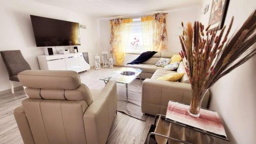 a living room with a couch and a tv at Carpe Diem Lakeside Apartment in Szczecin