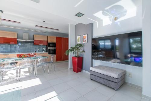 a kitchen and dining room with a table and chairs at Crystal Waves lux villa-Homeleader in Chania Town
