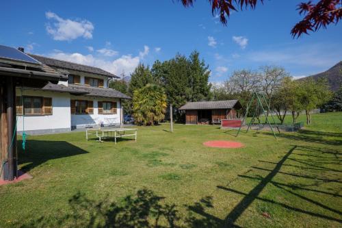 a yard with a playground and a swing at Villa Palma in Colico