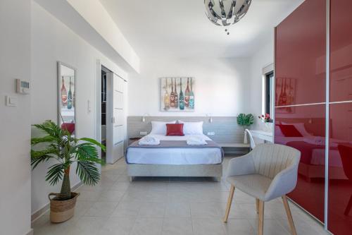 a bedroom with a bed and a chair in it at Crystal Waves lux villa-Homeleader in Chania Town