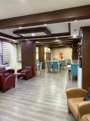 a waiting room with tables and couches and chairs at Hotel Ferah in Araklı