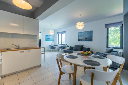 a kitchen and a living room with a table at Crystal Waves lux villa-Homeleader in Chania Town