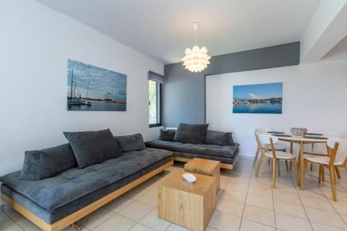 a living room with a couch and a table at Crystal Waves lux villa-Homeleader in Chania Town