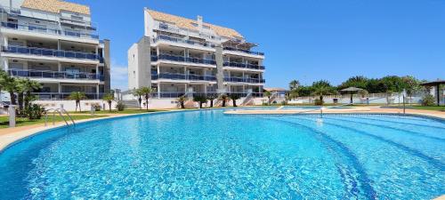 a large swimming pool in front of a building at Apartamento Jardines de Deveses by DENIA COSTA in Denia
