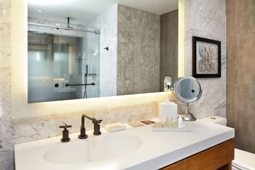 a bathroom with a sink and a mirror at Renaissance New York Midtown Hotel in New York