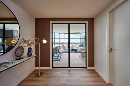 a hallway with a door leading to a living room at Rotterdam Marriott Hotel in Rotterdam