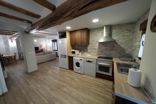 a kitchen with a sink and a stove top oven at Casa Rural Casa Clemen in Villalba Baja