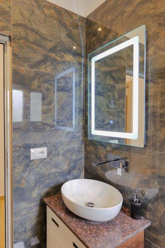 a bathroom with a sink and a mirror at Casa Del Mar in Ksamil