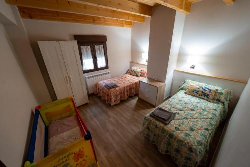a small room with a bed and a couch at Casa Rural Casa Clemen in Villalba Baja
