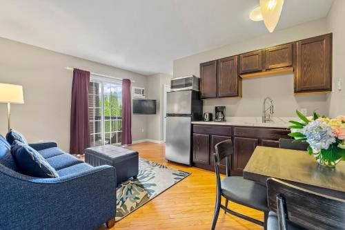 a kitchen and living room with a table and chairs at Sea Rose Suites in Ogunquit
