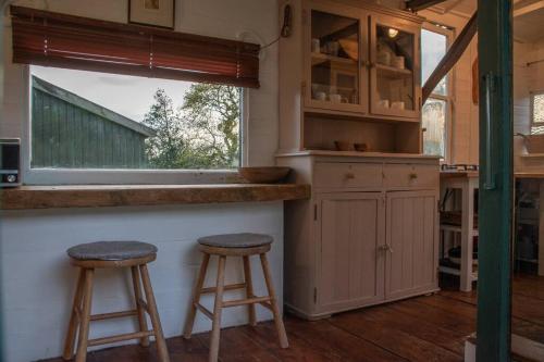 Shepherds Hut in enclosed field photo 11
