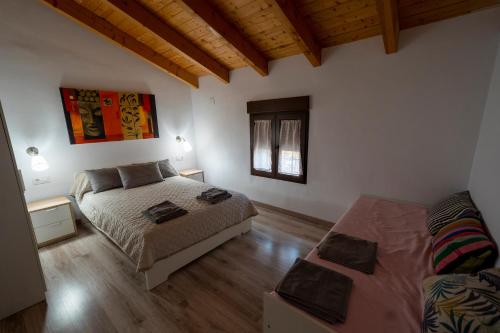 a bedroom with a bed and a couch at Casa Rural Casa Clemen in Villalba Baja