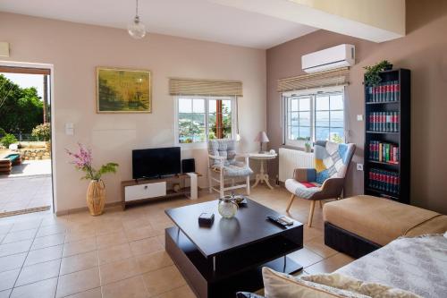 a living room with a couch and a table at Seashore Apartments in Chorafakia