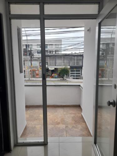 an open door to a room with a window at Casa Colibrí Hospedaje Manizales a 2 min del Cable y 1 min Zona G in Manizales