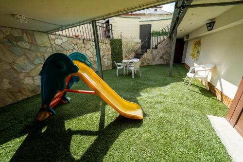 a slide in the back yard of a house at Casa Rural Casa Clemen in Villalba Baja