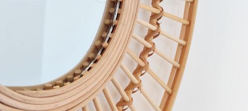 a close up of a wooden chair with a mirror at Apartamento Jardines de Deveses by DENIA COSTA in Denia