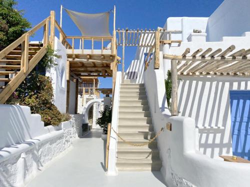 a stairway leading up to a building with white stairs at Apsenti couples only in Agios Ioannis Mykonos