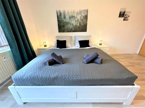 a bedroom with a large bed with two pillows at COZY Apartment in Bavarian Forest +POOL +SAUNA +NETFLIX in Zwiesel