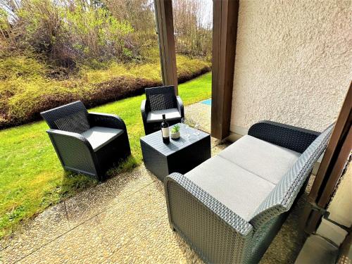 a patio with two chairs and a table and two chairs at COZY Apartment in Bavarian Forest +POOL +SAUNA +NETFLIX in Zwiesel