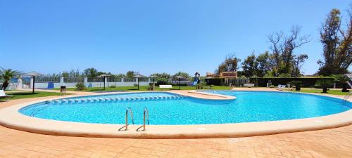 a large swimming pool in a park at Apartamento Jardines de Deveses by DENIA COSTA in Denia