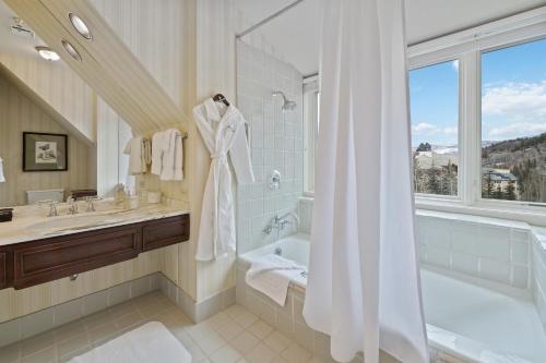 a bathroom with a tub and a sink and a shower at Poste Montane Lodge by East West in Beaver Creek