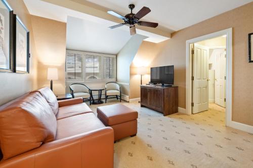 a living room with a couch and a flat screen tv at Poste Montane Lodge by East West in Beaver Creek