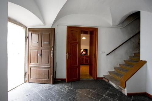 a hallway with a door and a staircase in a house at Apartmán Mariánská 5 in Olomouc