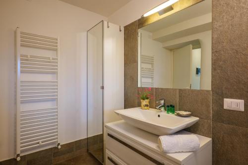 a bathroom with a sink and a mirror at Residence Girasole Casa Rossa B in Colico