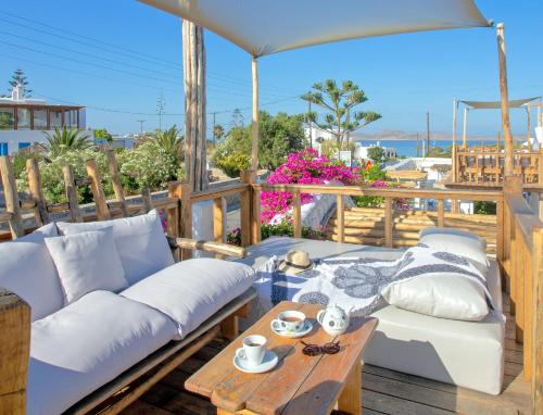 a living room with a couch and a table at Apsenti couples only in Agios Ioannis Mykonos