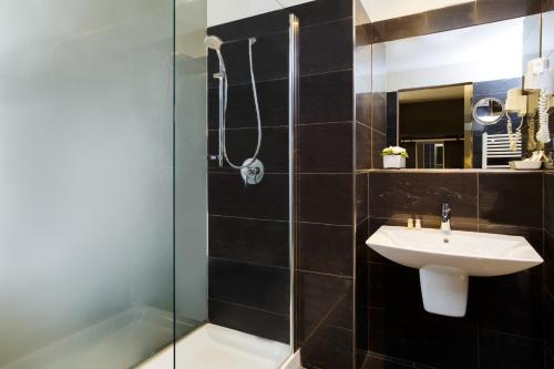 a bathroom with a sink and a shower at Best Western Plus Royal Superga Hotel in Cuneo