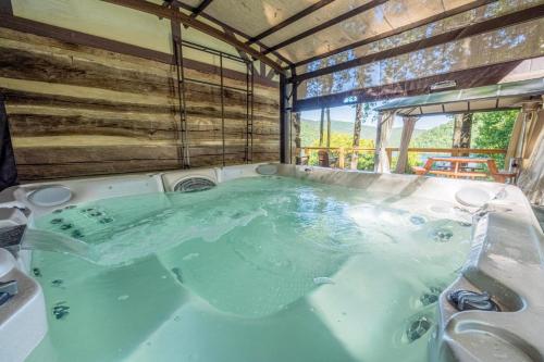 a jacuzzi tub in a house with a sink at Chestnut Lodge - Family Cabin on Lake Nantahala in Topton