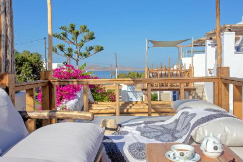 a patio with a table and chairs on a balcony at Apsenti couples only in Agios Ioannis Mykonos