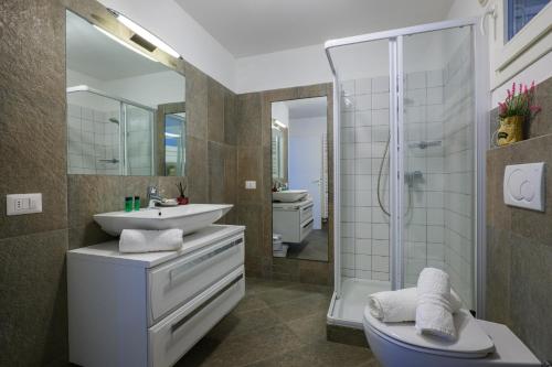 a bathroom with a sink toilet and a shower at Residence Girasole Casa Gialla in Colico