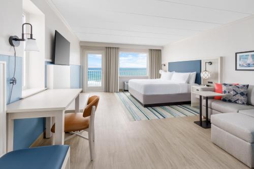 a hotel room with a bed and a couch at Hilton Garden Inn Ocean City Oceanfront in Ocean City