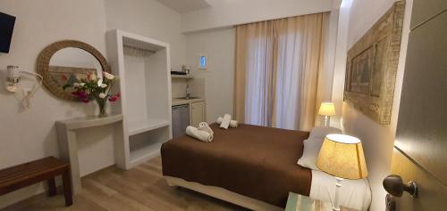 a hotel room with a bed and a mirror at Naxos Lane Center Studios in Naxos Chora