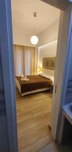 a bedroom with a bed with a brown bedspread at Naxos Lane Center Studios in Naxos Chora