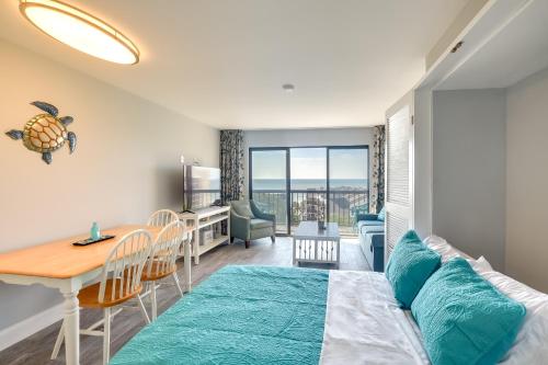 a bedroom with a bed and a dining room with a table at Myrtle Beach Condo with Ocean View and Pool Access! in Myrtle Beach