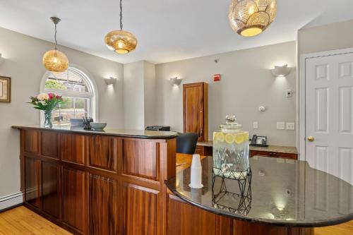 a kitchen with a glass counter and a table at Sea Rose Suites in Ogunquit