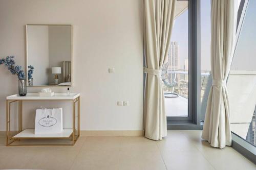 a bathroom with a sink and a mirror and a window at LARBI Breathtaking Burj and Fountain View Luxurious 2 Bed in Dubai