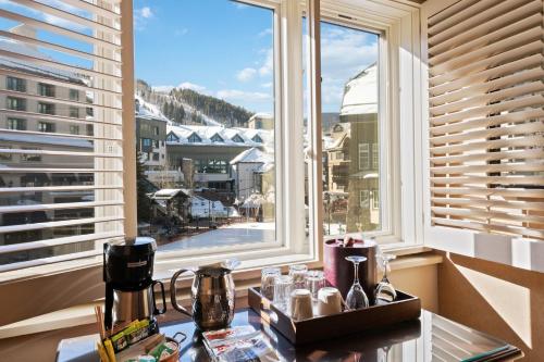 a kitchen with a view of a city from a window at Poste Montane Lodge by East West in Beaver Creek