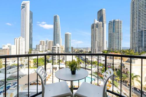 a balcony with a table and chairs and a city at Gorgeous Studio right in the heart of Surfers in Gold Coast